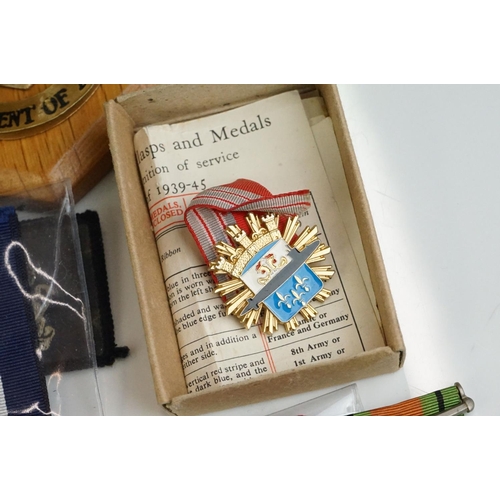 274 - A group of military collectables to include a framed set of Royal Army Ordnance corps badges, a sele... 