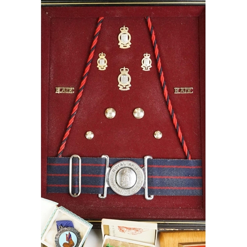 274 - A group of military collectables to include a framed set of Royal Army Ordnance corps badges, a sele... 