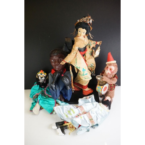 281 - A small group of collectables to include souvenir doll, hand puppets and wind up monkey.