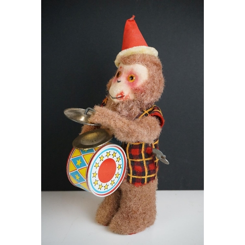 281 - A small group of collectables to include souvenir doll, hand puppets and wind up monkey.