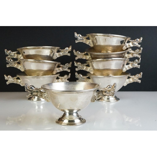 288 - A set of eight white metal Chinese finger bowls with dragon handles.