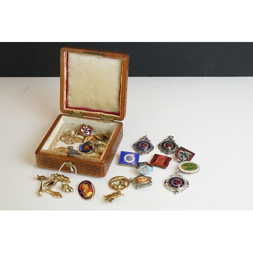 304 - Collection of pocket watch fobs, enamel badges & yellow metal charms