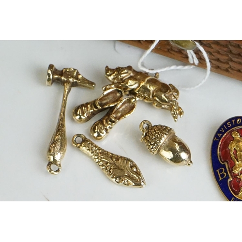 304 - Collection of pocket watch fobs, enamel badges & yellow metal charms