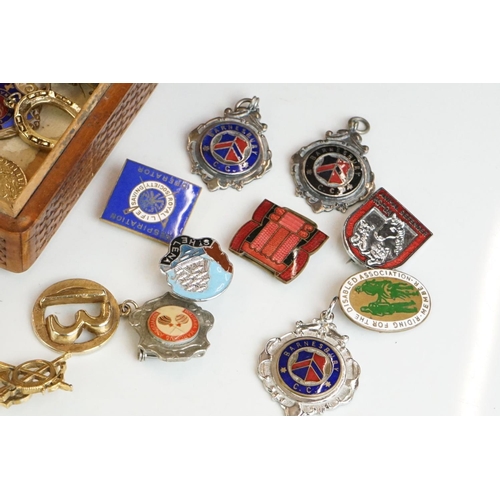 304 - Collection of pocket watch fobs, enamel badges & yellow metal charms