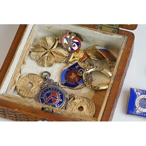 304 - Collection of pocket watch fobs, enamel badges & yellow metal charms