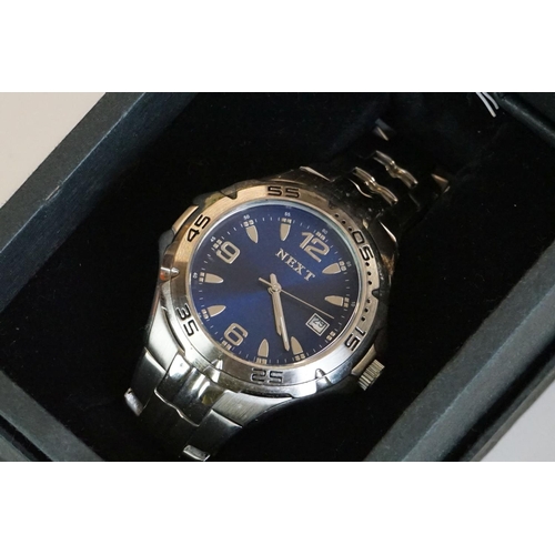 311 - A collection of gents and ladies fashion watches all within original boxes to include Casio and Gues... 