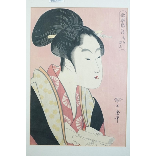 466 - Kitagawa Utamaro, a signed Japanese woodblock portrait of a lady in traditional costume, holding a s... 