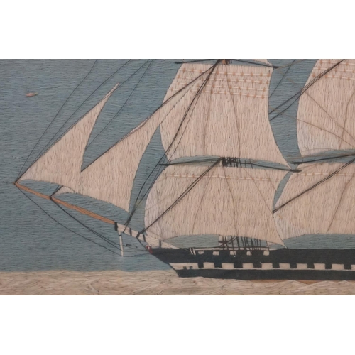 514 - 19th century Woolwork Embroidery of a Three Mast Sailing Ship at Sea, 47cm x 76cm, framed and glazed