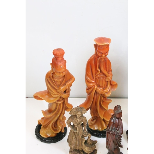 347 - A collection of oriental carved wooden figures together with a lampshade in the form of a lily.