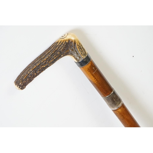 275A - An antique sword stick with white metal collars and antler handle, the blade maker marked for E. Thu... 