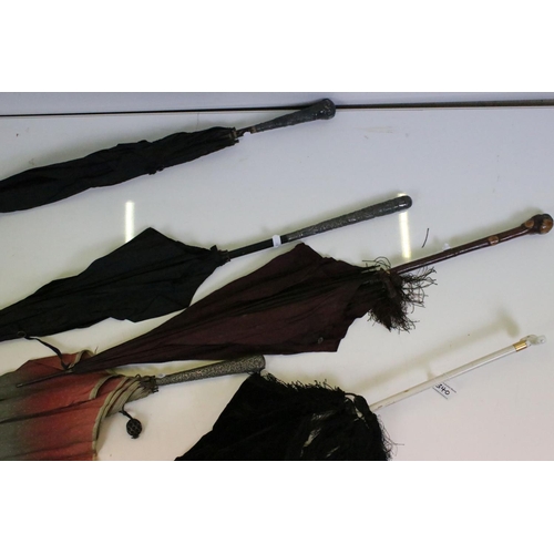 340 - A collection of five umbrellas and parasols to include hallmarked silver handled examples.