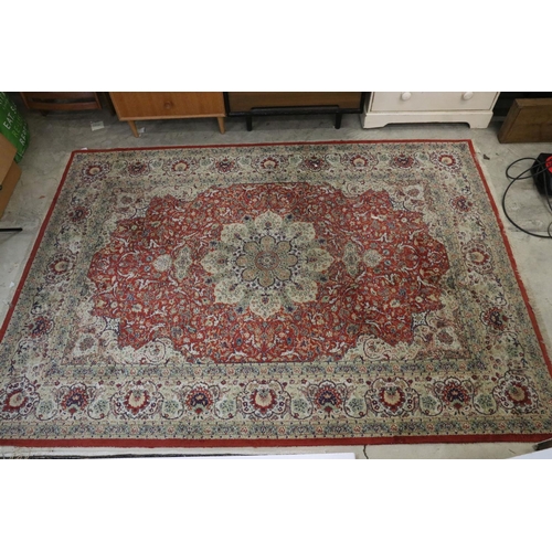 576 - Red Ground Rug with Perisan style design, approximately 236cm x 168cm