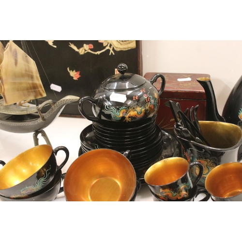 345 - A group of oriental collectables to include tea set, wall plaque, tea caddy and ornamental junk boat... 