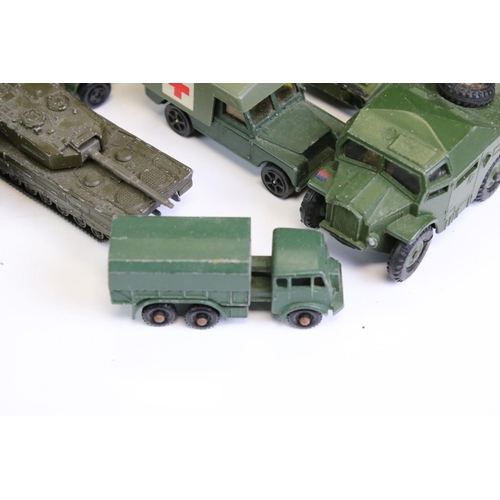 1306 - 55 Mid 20th C onwards play worn military-related diecast models to include Dinky, Britains, Solido, ... 