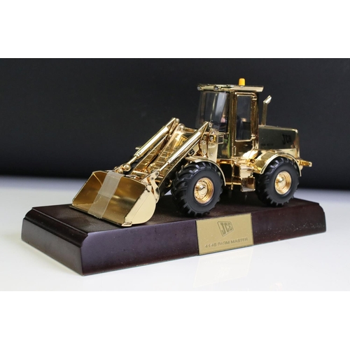 1225 - Boxed JCB 414S Farm Master diecast model finished in gold plate, diecast shows light surface scratch... 