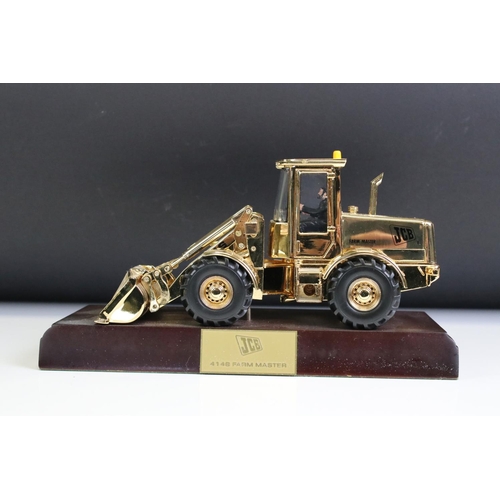 1225 - Boxed JCB 414S Farm Master diecast model finished in gold plate, diecast shows light surface scratch... 