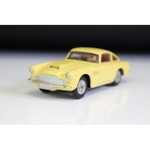 1386A - Boxed Corgi 218 Aston Martin DB4 diecast model in yellow with red interior, diecast vg with some gru... 