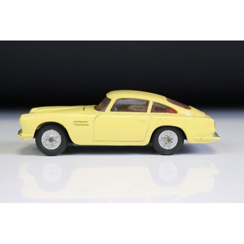 1386A - Boxed Corgi 218 Aston Martin DB4 diecast model in yellow with red interior, diecast vg with some gru... 