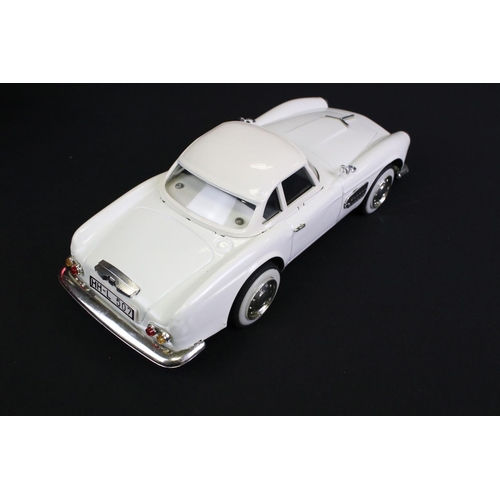 236 - Four boxed tin plate friction powered models to include Standard Sedan in white with pink hood, Leme... 