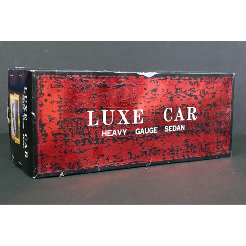 236 - Four boxed tin plate friction powered models to include Standard Sedan in white with pink hood, Leme... 