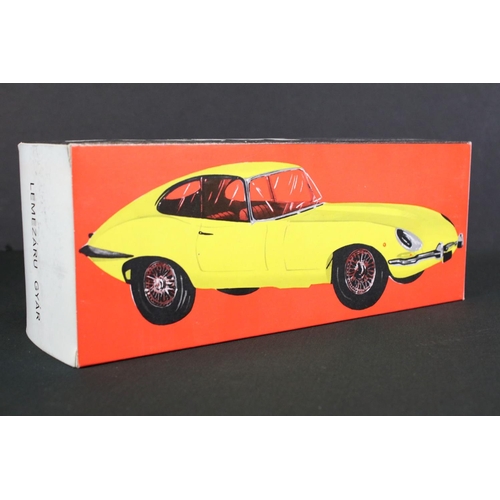 236 - Four boxed tin plate friction powered models to include Standard Sedan in white with pink hood, Leme... 