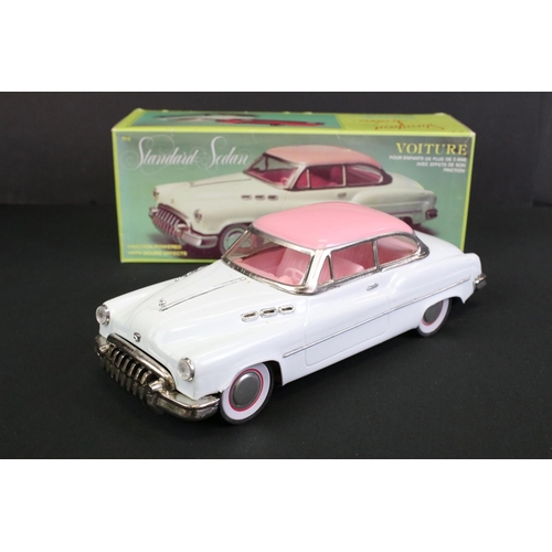 236 - Four boxed tin plate friction powered models to include Standard Sedan in white with pink hood, Leme... 