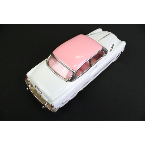 236 - Four boxed tin plate friction powered models to include Standard Sedan in white with pink hood, Leme... 