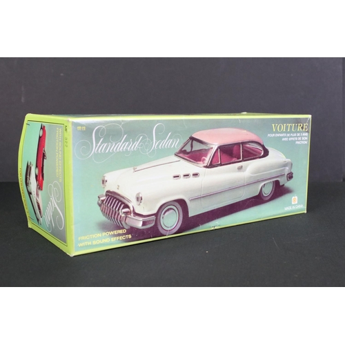 236 - Four boxed tin plate friction powered models to include Standard Sedan in white with pink hood, Leme... 