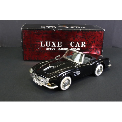 236 - Four boxed tin plate friction powered models to include Standard Sedan in white with pink hood, Leme... 