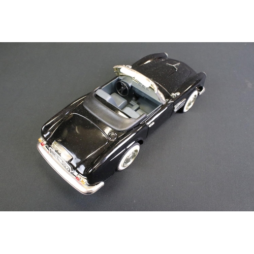 236 - Four boxed tin plate friction powered models to include Standard Sedan in white with pink hood, Leme... 