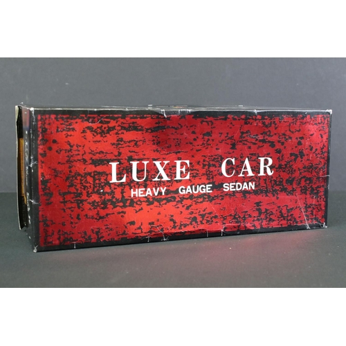 236 - Four boxed tin plate friction powered models to include Standard Sedan in white with pink hood, Leme... 