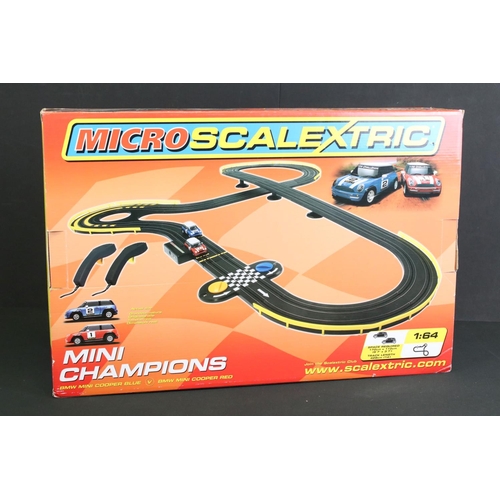 265 - Two Boxed Micro Scalextric 1:64 Mini Champions 'BMW Mini Cooper Blue V BMW Mini Cooper Red' sets, pl... 