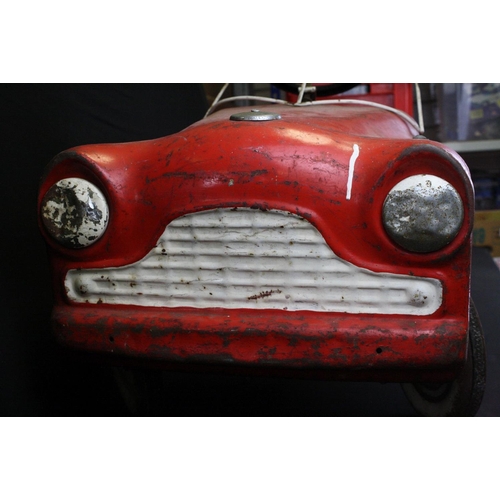 231 - Sharna Triang metal pedal car in red with white grill and hubs, mid 20th C, shows rusting