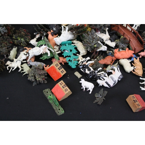 344 - Collection of plastic farmyard animals along with some diecast accessories & wooden buildings