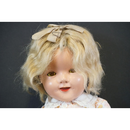 410 - Four circa early - mid 20th C plastic and composition dolls to include an Ideal Shirley Temple doll ... 