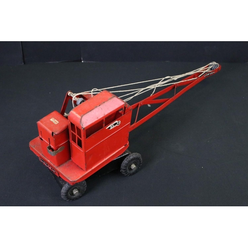 286 - Five Triang tin plate metal Jones cranes in red to include 2 x boxed examples, models gd with some w... 