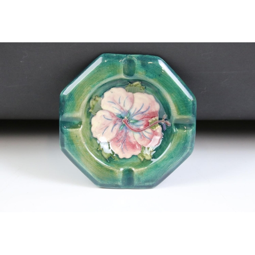 58 - Moorcroft - A William Moorcroft ' Hibiscus ' pattern ashtray together with an ' Anemone ' astray and... 