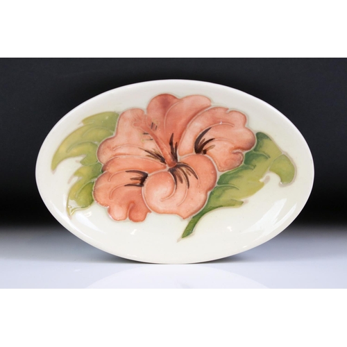 58 - Moorcroft - A William Moorcroft ' Hibiscus ' pattern ashtray together with an ' Anemone ' astray and... 