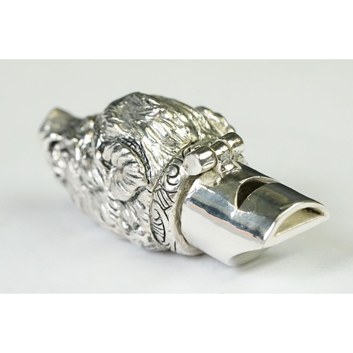 219 - A silver plated whistle and vesta case in the form of a boars head with ruby eyes