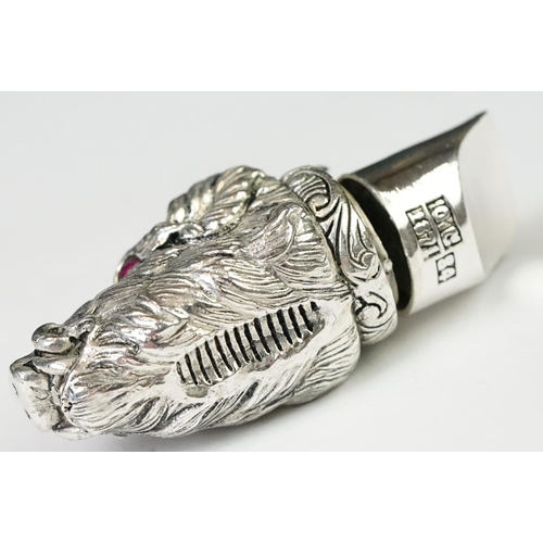 219 - A silver plated whistle and vesta case in the form of a boars head with ruby eyes