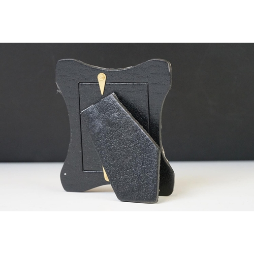 220 - A silver easel back picture frame with embossed decoration