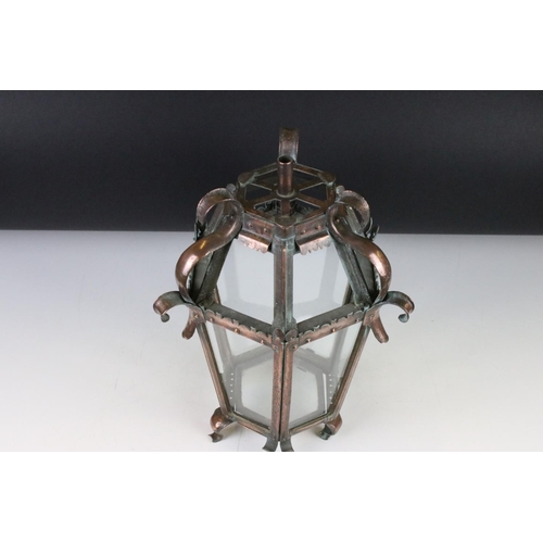 120 - Early 20th century Arts & Crafts glazed copper lantern, of hexagonal form, raised on four scrolling ... 