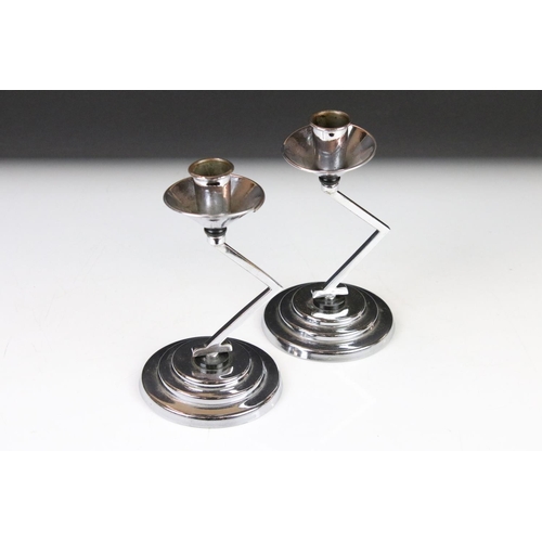 121 - Pair of Art Deco Chromium Candlesticks with angular column supports and circular stepped bases, 18cm... 