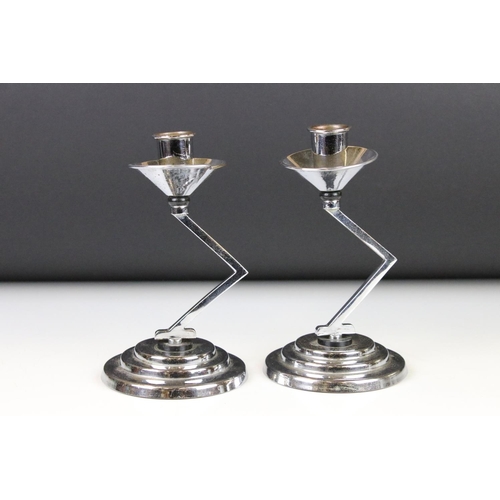 121 - Pair of Art Deco Chromium Candlesticks with angular column supports and circular stepped bases, 18cm... 