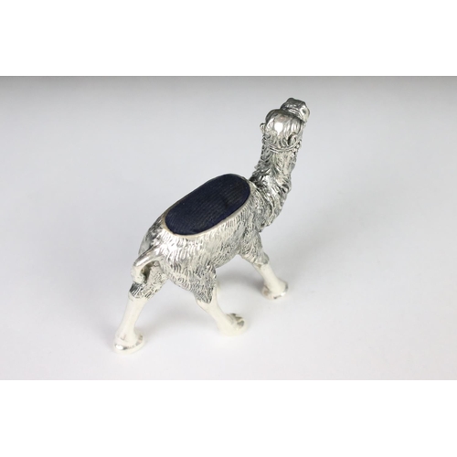 205 - A large silver plated camel style pincushion.