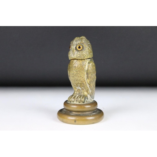 206 - A cast metal table top inkwell in the form of an owl with glass eyes and flip top lid.