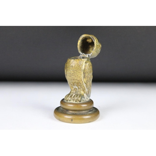 206 - A cast metal table top inkwell in the form of an owl with glass eyes and flip top lid.