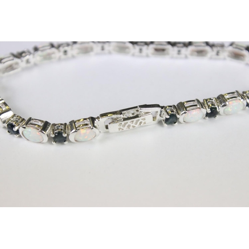 274 - A silver opal and sapphire line bracelet.