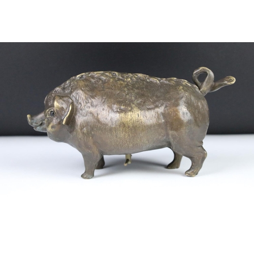 276 - A bronze table top bell in the form of a pig.