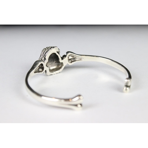 279 - A silver skeleton style bangle.